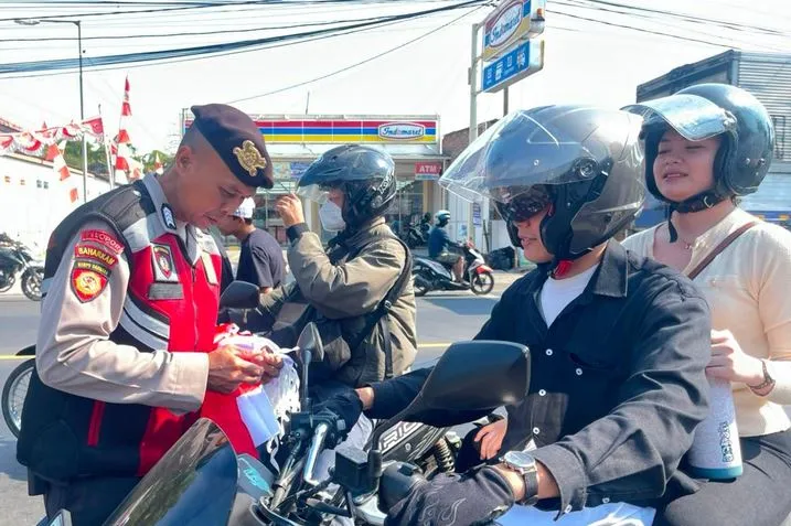polres-mojokerto-bagikan-150-bendera-merah-putih,-ajak-warga-semarakkan-hut-ke-81-ri